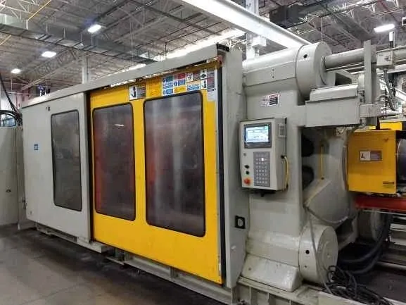 Industrial plastic injection molding machine in factory.