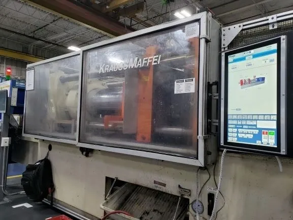 Industrial injection molding machine with control panel.