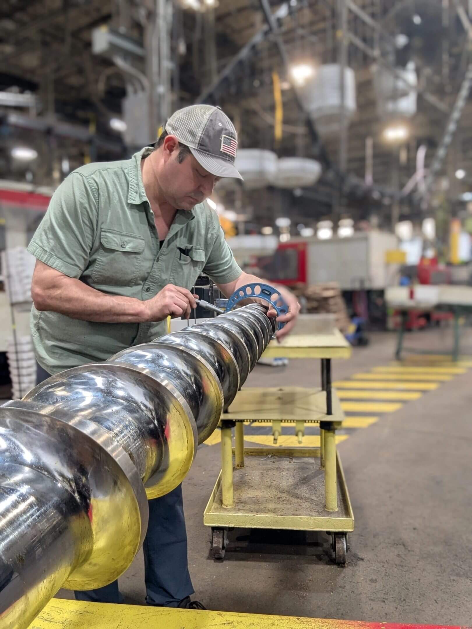 Man inspecting large metal industrial component.